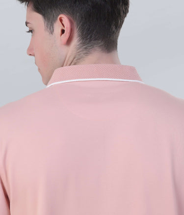 Close-up of a man's neck and collar of a pink polo shirt, showcasing breathable fabric and stylish design.