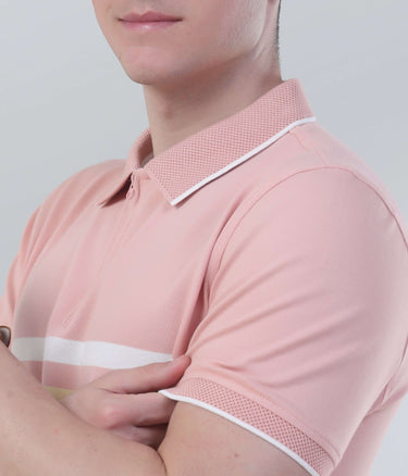Man wearing a pink polo shirt with a stylish collar, showcasing comfort and modern design features.