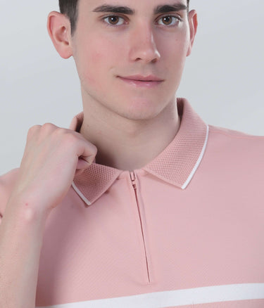 Model showcasing a pink zipped polo t-shirt with a stylish collar and modern design features.