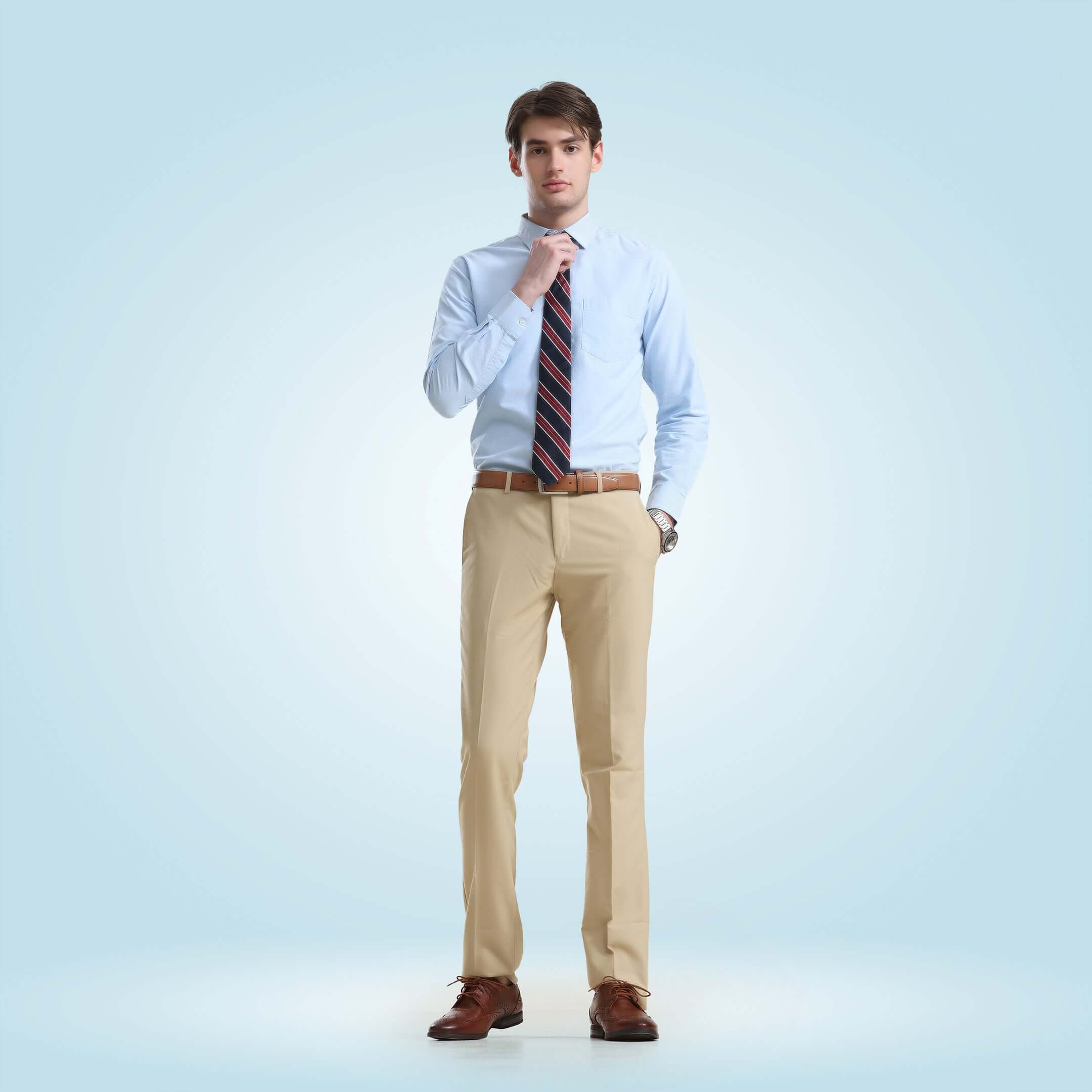 Man wearing Oxford Turms blue shirt and beige trousers with striped tie, showcasing premium anti-stain, anti-odour intelligent apparel.