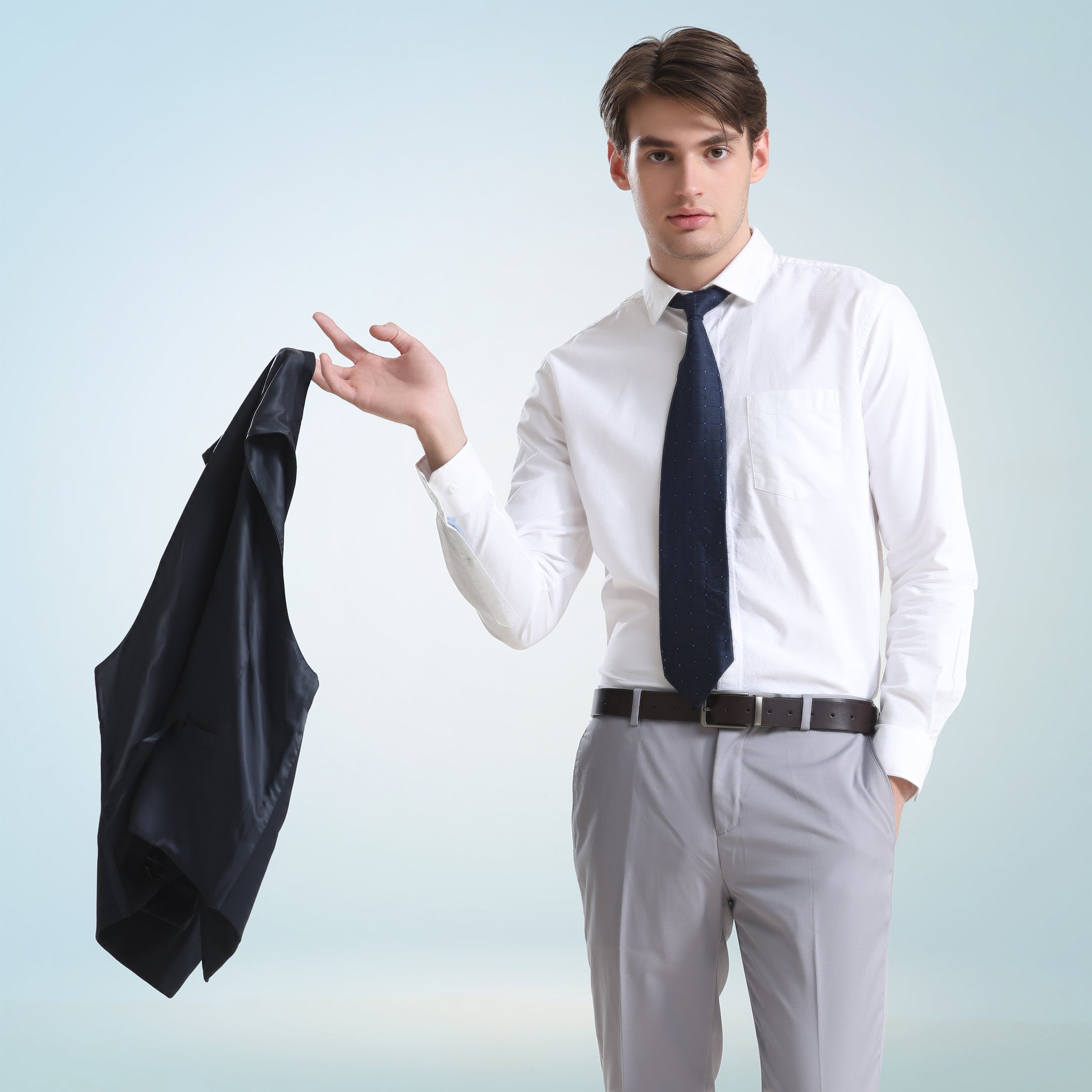 Man wearing a Moonlite White Oxford Turms premium cotton shirt, holding a jacket. Anti-stain, anti-odour intelligent apparel.