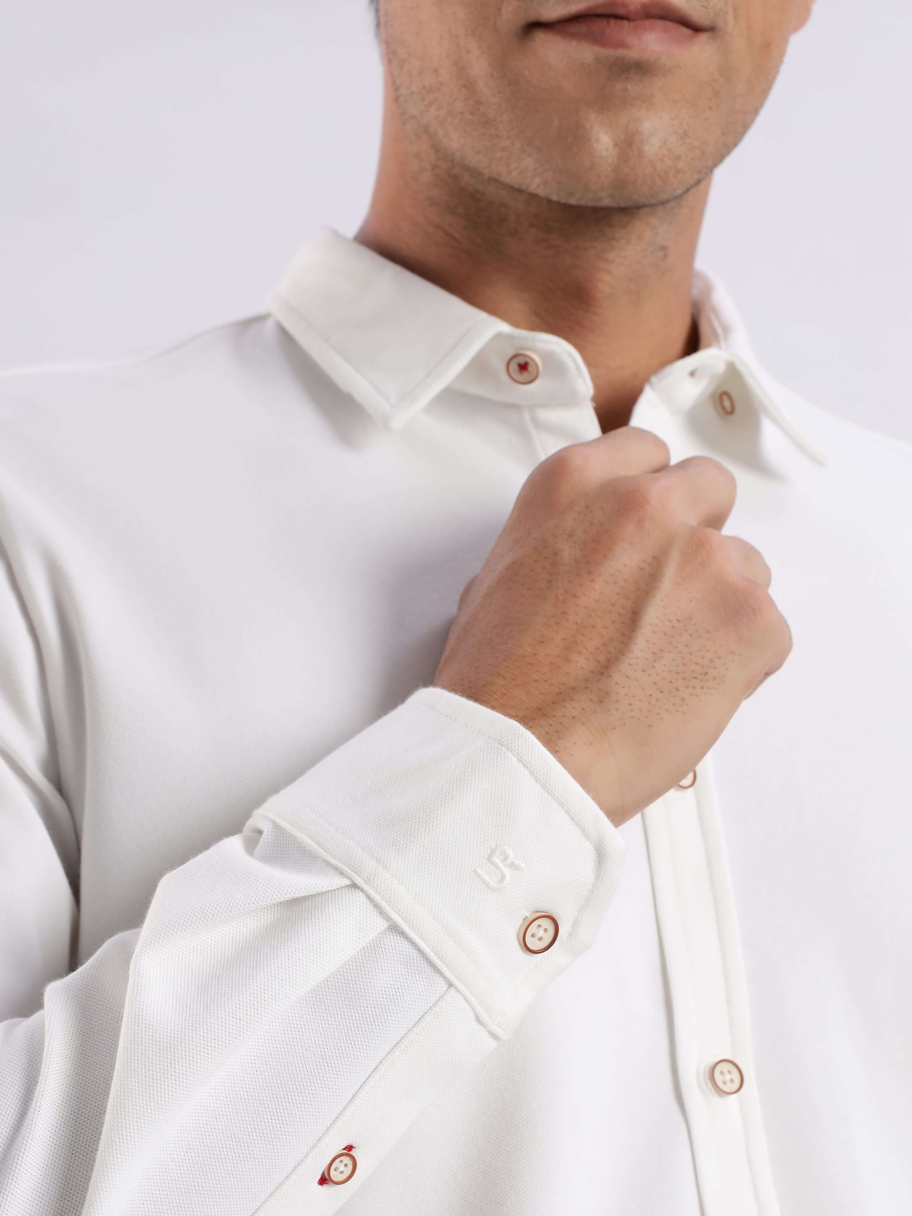 Man wearing a White Willow knitted shirt with buttons, showcasing premium quality and 8-way stretch features.