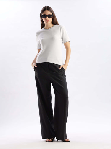 Model wearing a Nova Grey cooltech tshirt with wide-leg pants and sunglasses, showcasing stylish comfort.