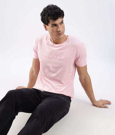 Man wearing a Quartz Pink cotton tshirt, showcasing its stretchable, waterproof, and anti-odour features.