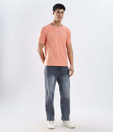 Model wearing Ember Orange Turms Worry-Free Intelligent T-Shirt, showcasing style and comfort.