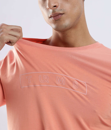 Man showcasing the Ember Orange Turms Worry-Free Intelligent T-Shirt, crafted from premium cotton fabric.