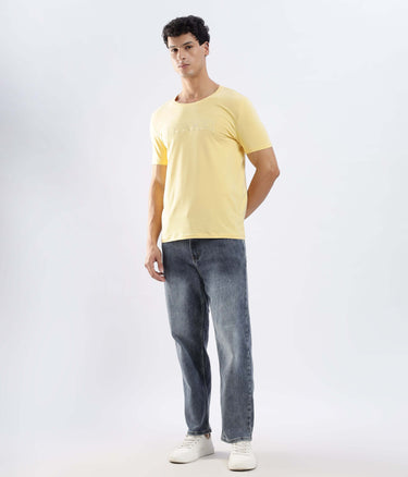 Model wearing Aura Yellow cotton tshirt, showcasing its stretchable, waterproof and anti-odour features.