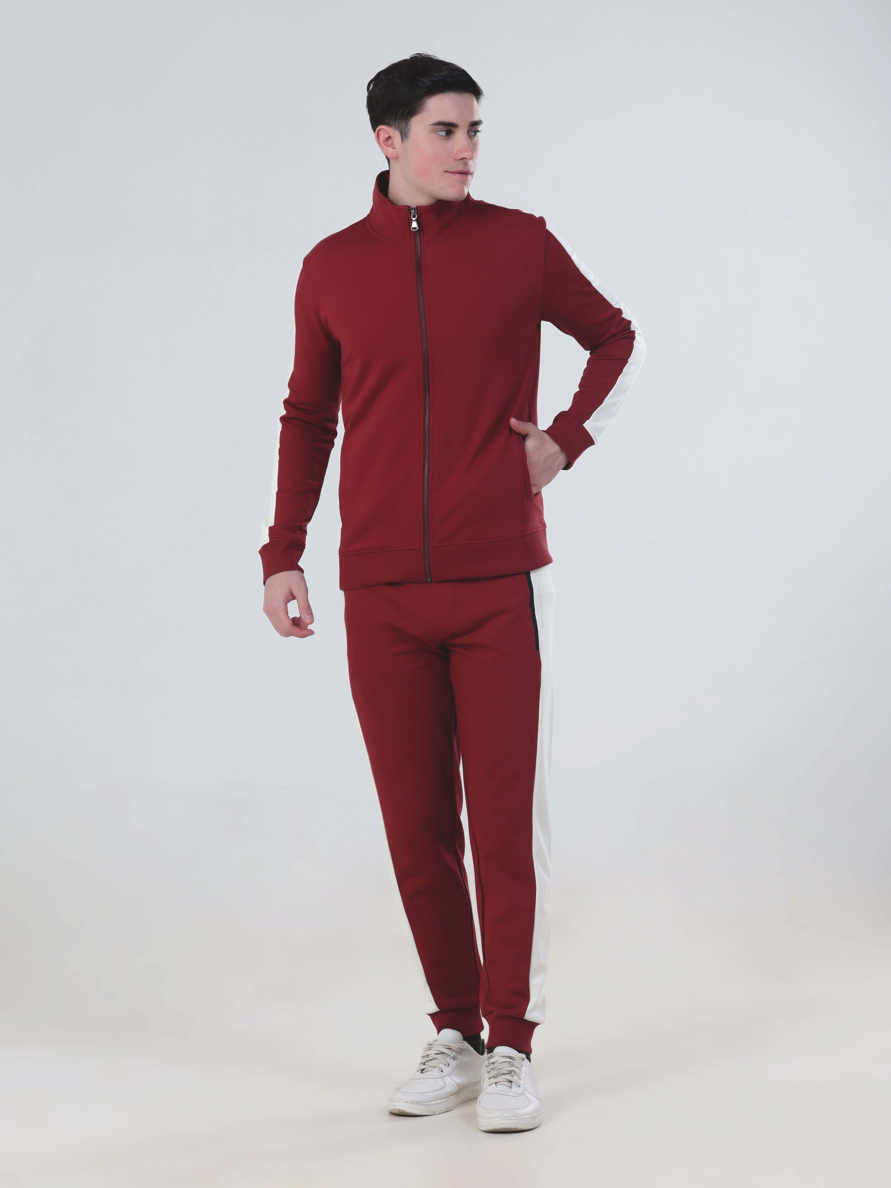 Man wearing Ruby Hunter co ord set in red, featuring a stylish zip jacket and joggers, made from breathable, water-resistant fabric.