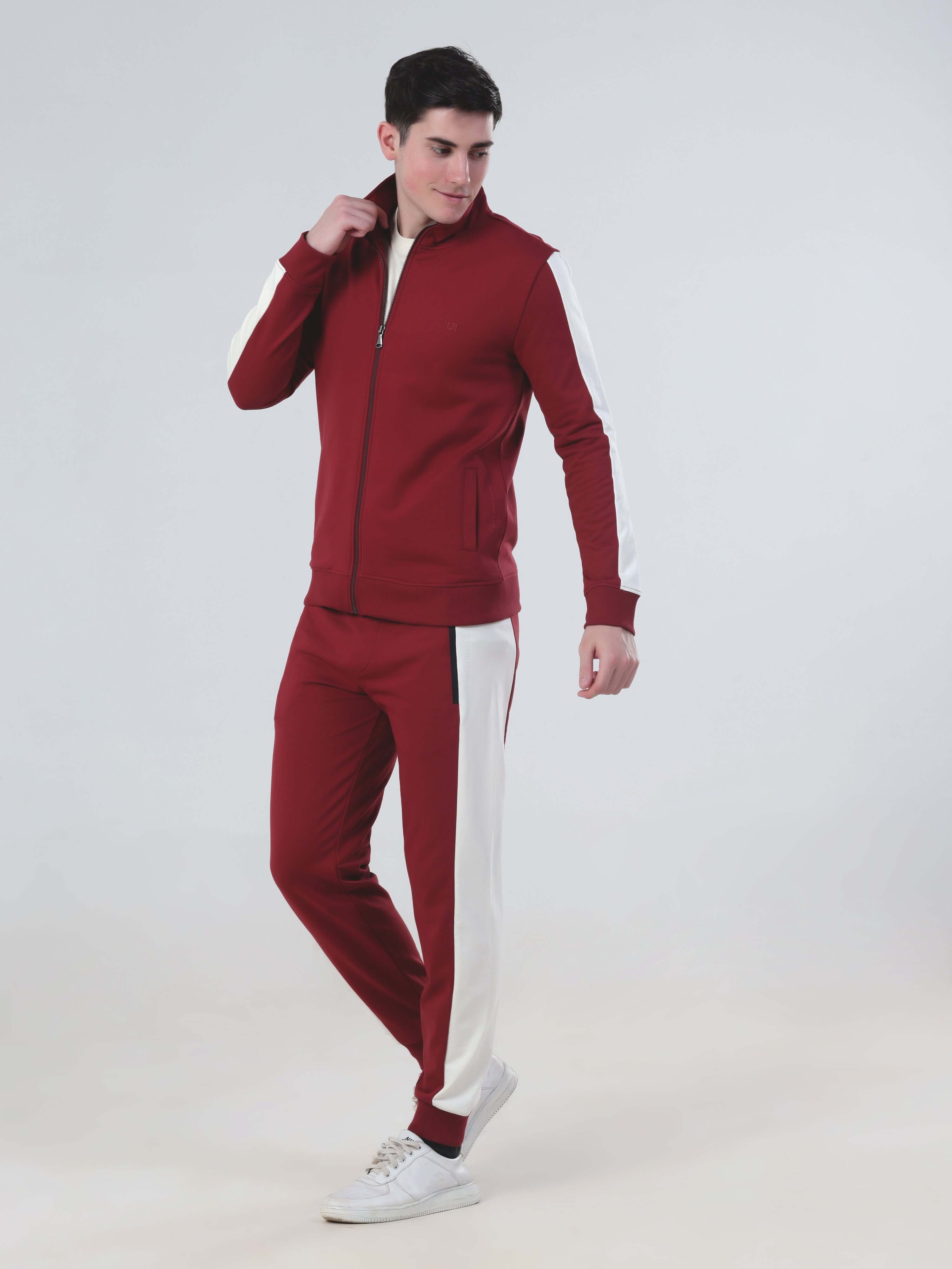 Stylish man in ruby red Turms Intelligent co-ord set, featuring water-resistant fabric and sporty design.