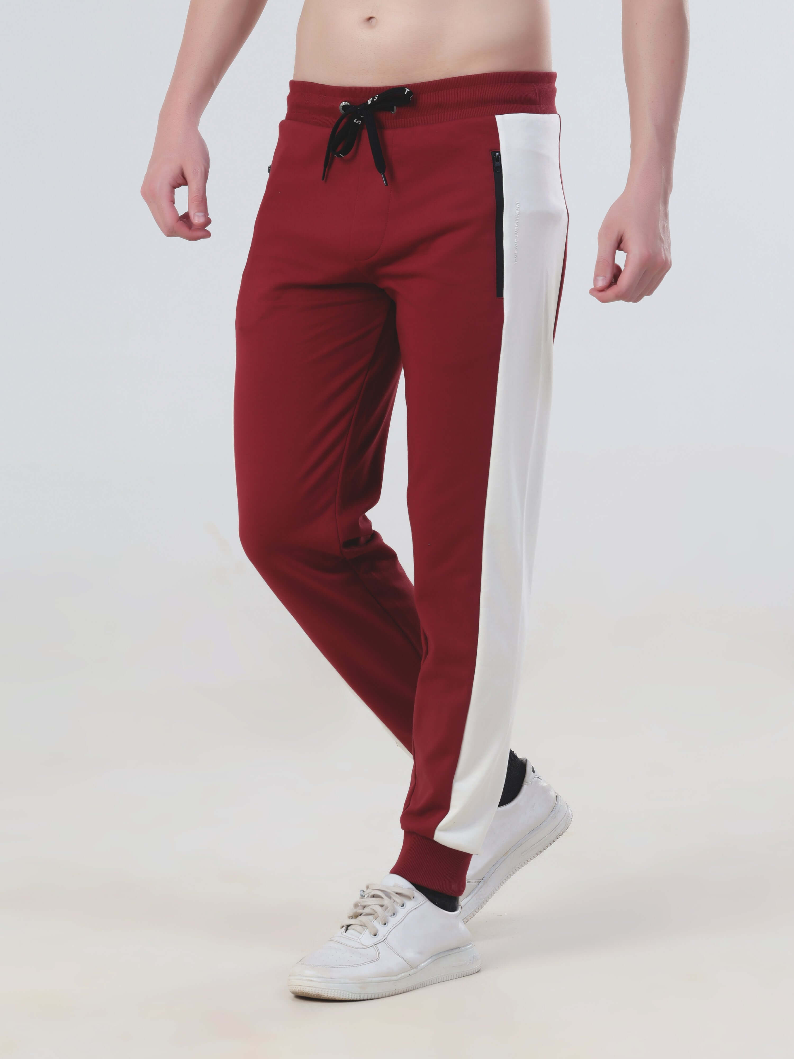 Men's red and white joggers, water-resistant, stylish design, part of Turms Intelligent co-ord set.