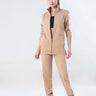 Woman wearing the Sandy Heaven coord set, featuring a stylish jacket and joggers in a beige color, perfect for travel and everyday wear.