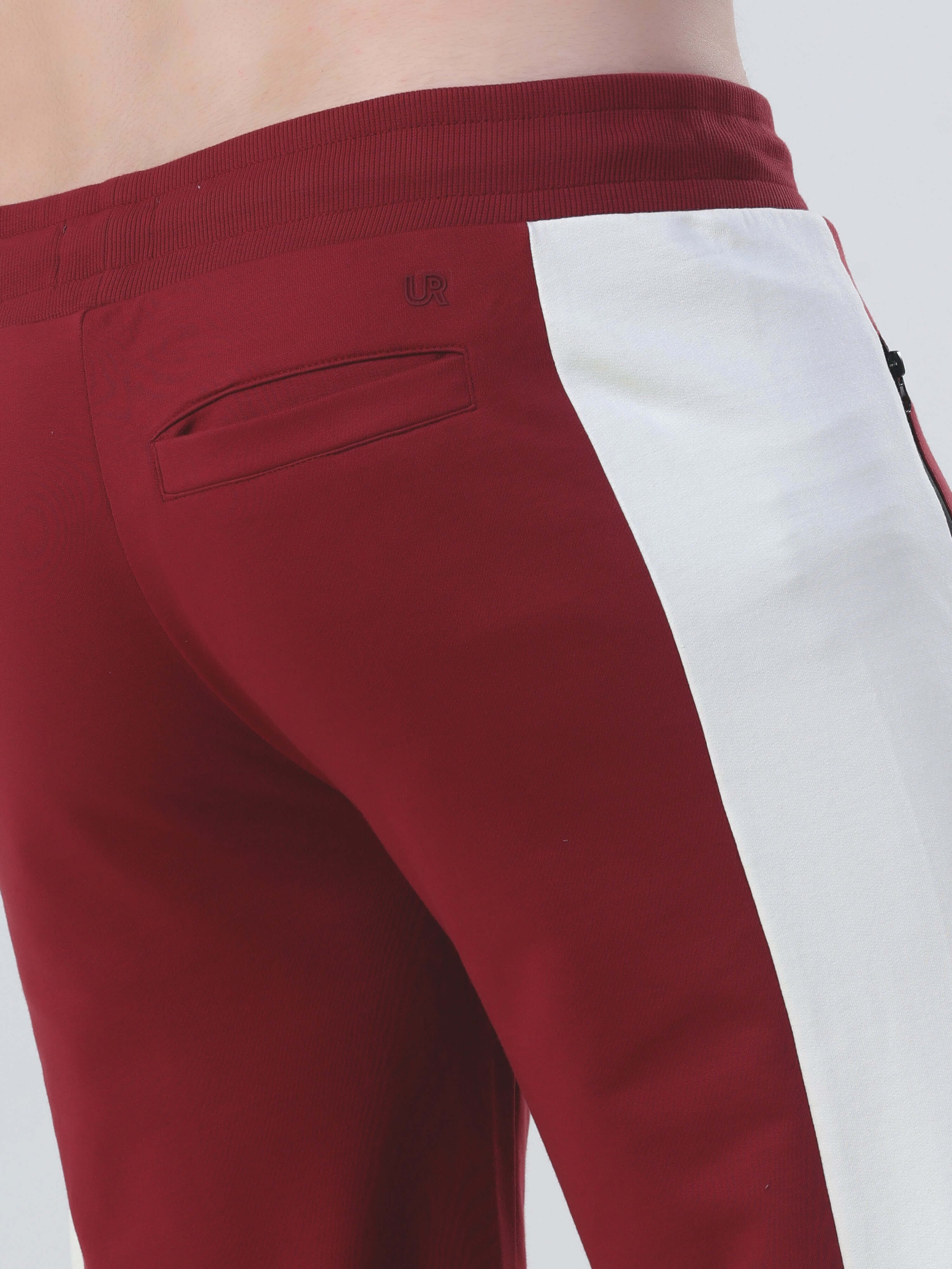 Close-up of the back of a maroon and white jogger featuring a zipper pocket, part of the Turms Intelligent co-ord set.