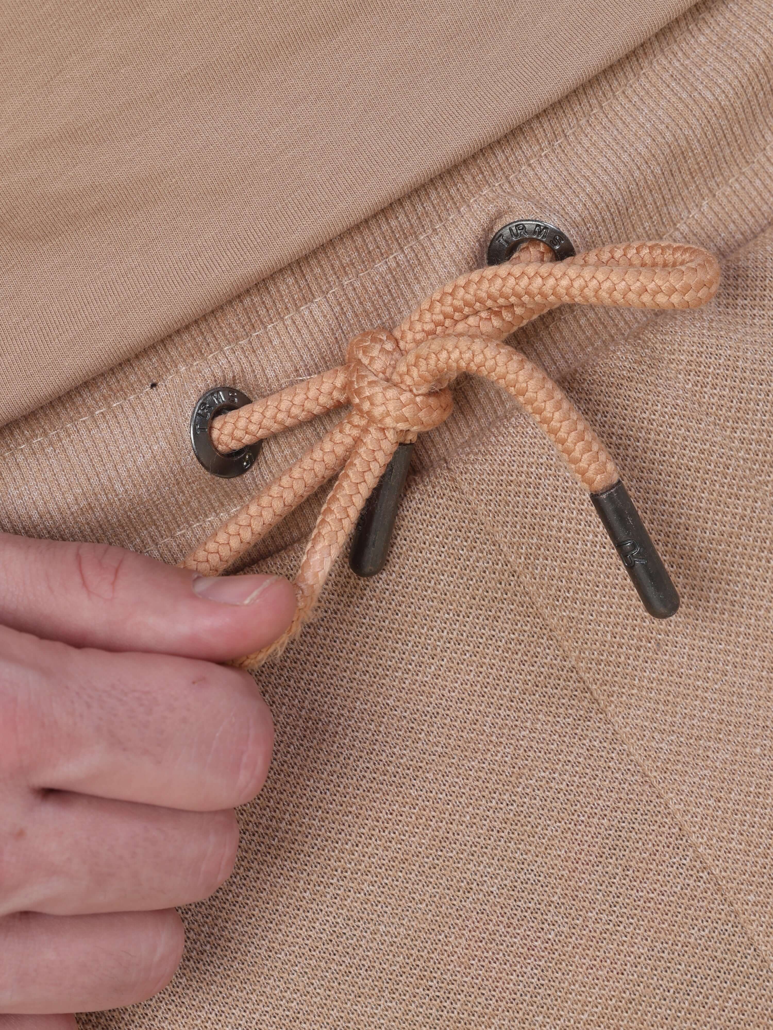 Close-up of Sahara Beige Turms Intelligent Jogger's drawstring detail, showcasing stylish design and functionality.