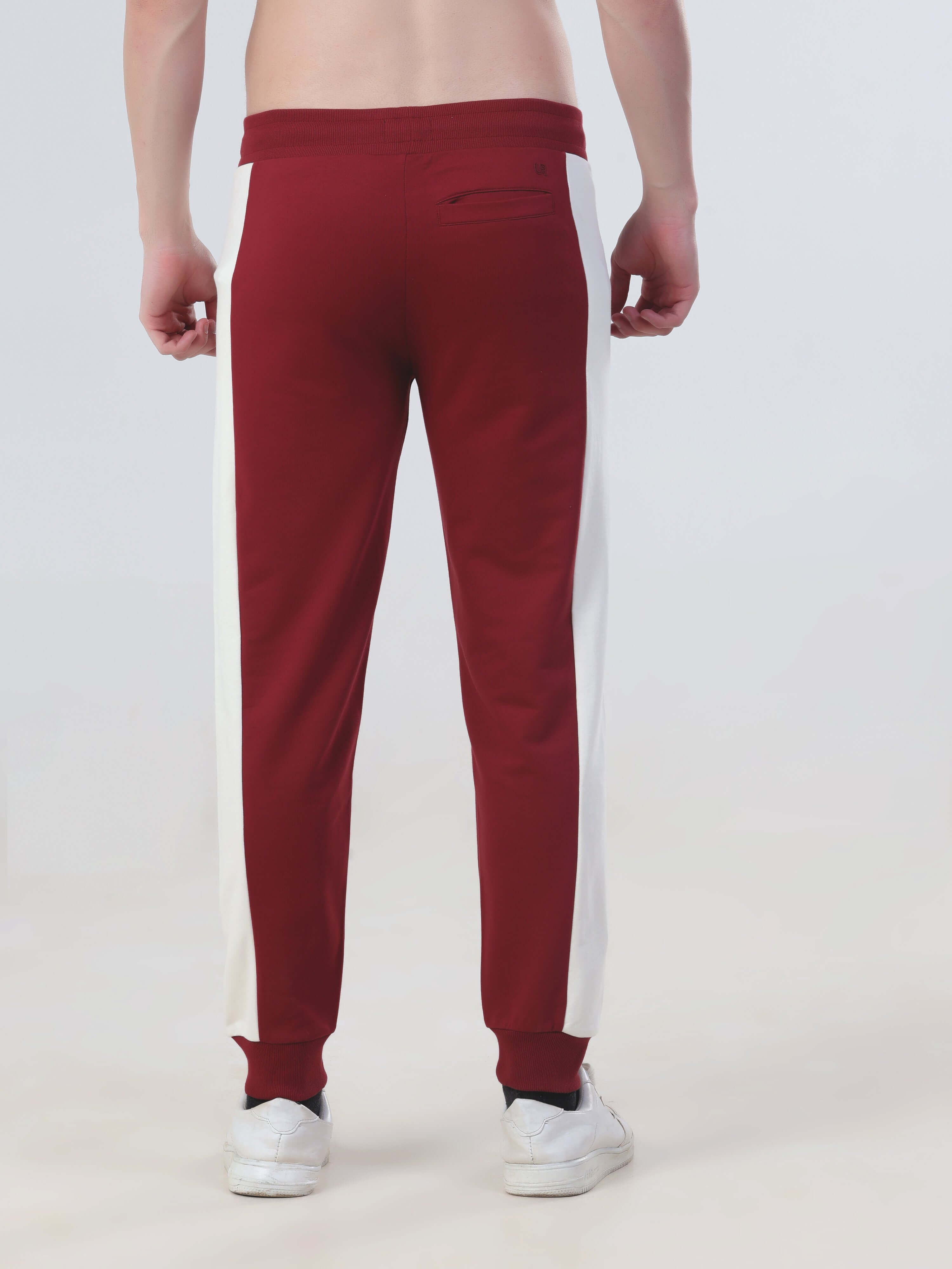 Men's burgundy joggers with white side panels, featuring a sporty design and comfortable fit for everyday wear.