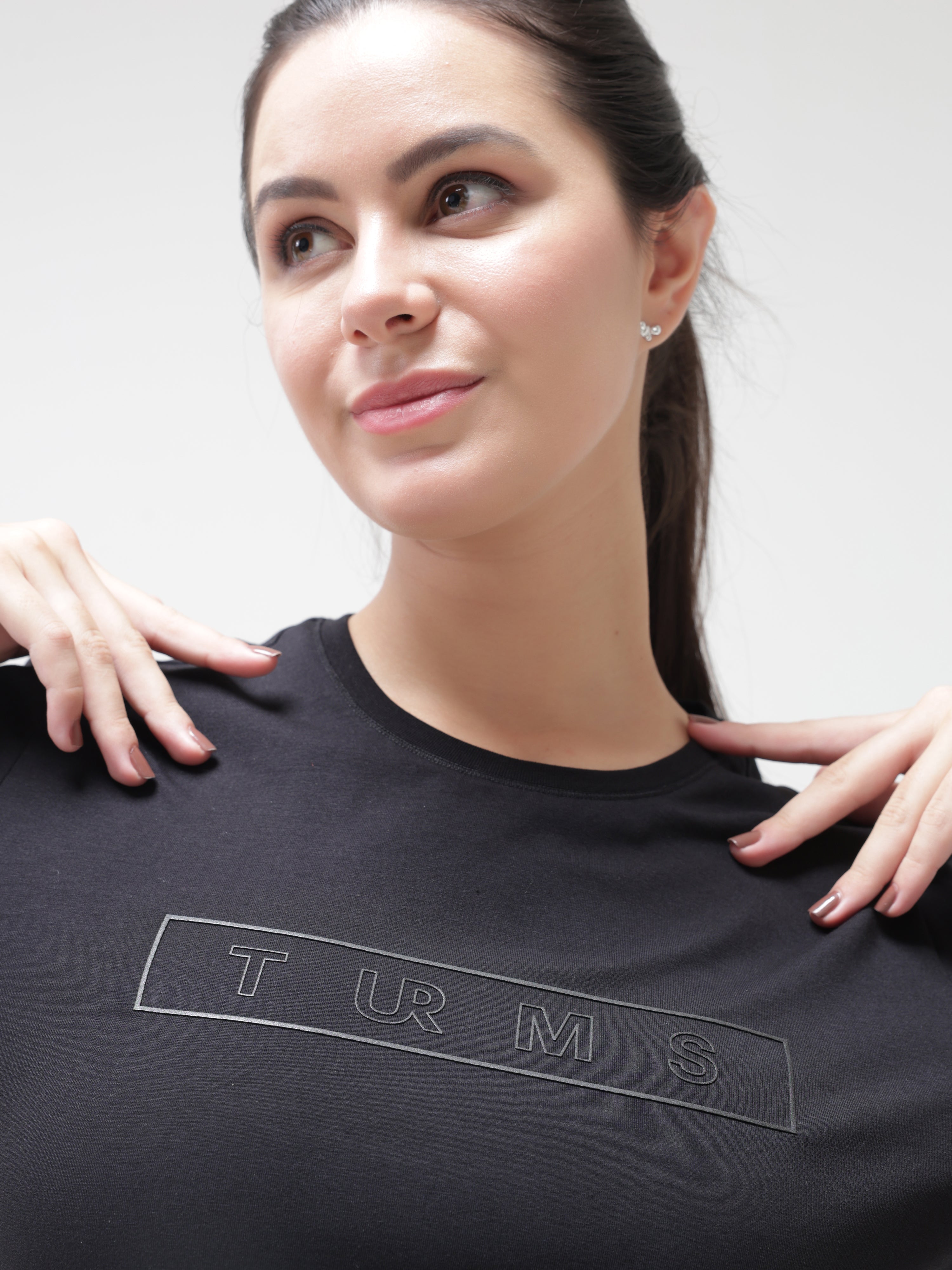 Woman wearing stain-proof and odor-resistant Turms T-shirt with round-neck, showcasing intelligent apparel technology, anti-stain, anti-odour, and stretchable fabric