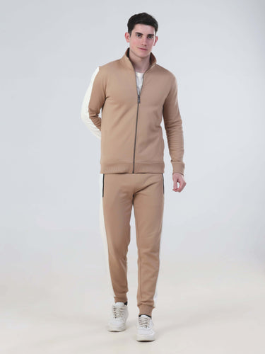 Model wearing Turms Intelligent co-ord set in beige, featuring a zip-up jacket and joggers, waterproof and stylish.