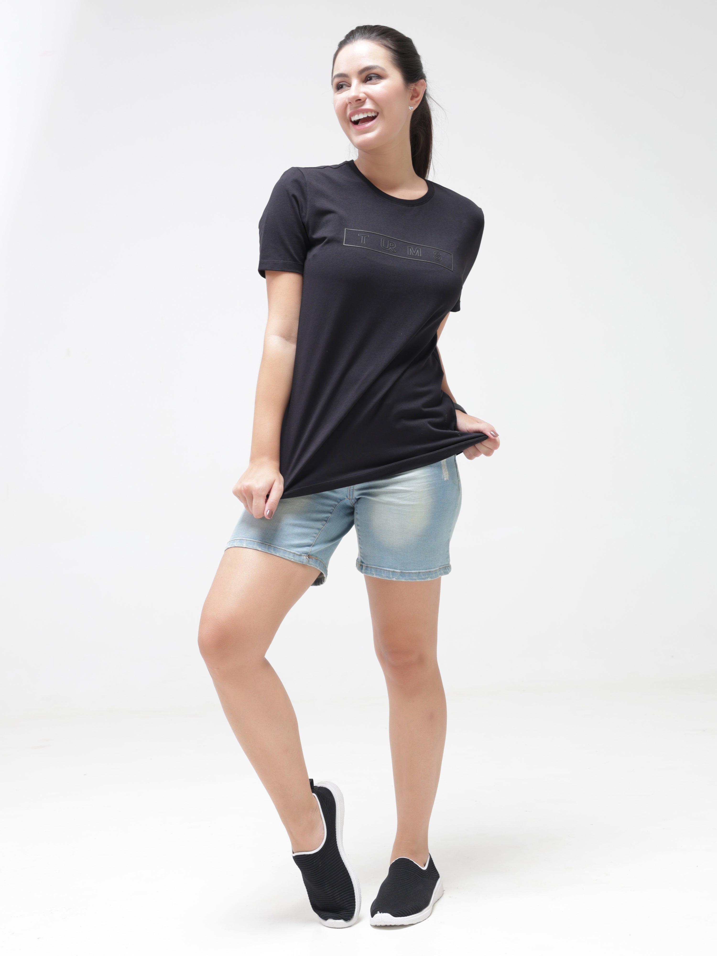 Woman wearing Midnight Elegance T-shirt by Turms, black round-neck, anti-stain, anti-odor, tailored fit, stretchable, premium cotton blend