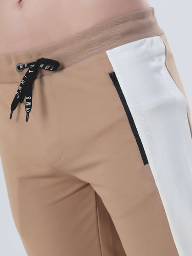 Sandy Heaven Turms Intelligent cord set joggers in tan with white panel, featuring adjustable waistband and stylish design.