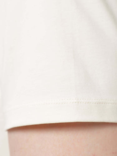 Close-up of Soft Peach Turms T-shirt showcasing stain-proof, anti-odor fabric made of premium cotton and spandex blend with tailored fit.