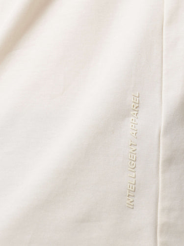 Soft peach Turms T-shirt fabric showcasing "Intelligent Apparel" text, anti-stain, anti-odour, stretchable, best trending tailored fit.