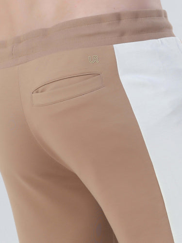 Close-up of Turms Intelligent co-ord joggers in beige and white, showcasing stylish design and comfortable fit.