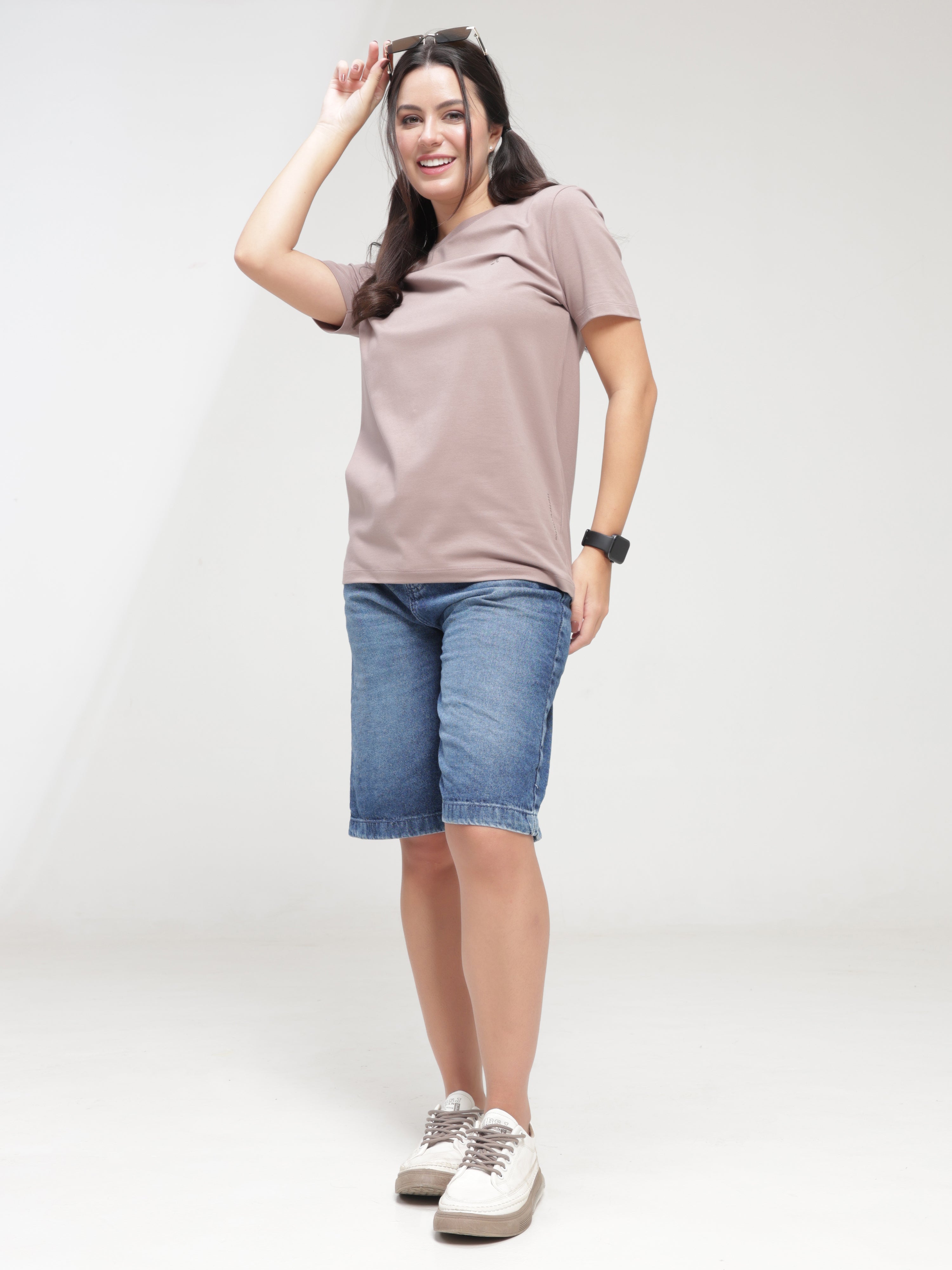 Woman wearing Dusky Maroon Turms T-shirt and jean shorts, stain-proof, anti-odour, stretchable, intelligent apparel, tailored fit, trending.
