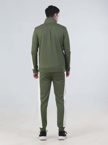 Back view of a man in a water-resistant Turms Intelligent co-ord set, featuring olive green jacket and joggers.