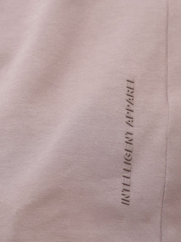 Close-up of Dusky Maroon stain-proof and odor-resistant round-neck Turms T-shirt with "INTELLIGENT APPAREL" text.