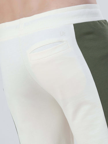 Close-up of stylish, eco-friendly joggers with cream and olive green panels from Turms Intelligent Apparel.
