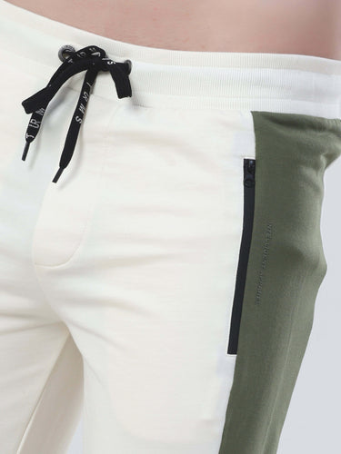 Close-up of Turms Intelligent Cord Set joggers featuring black zipper and drawstring in squid game colors.
