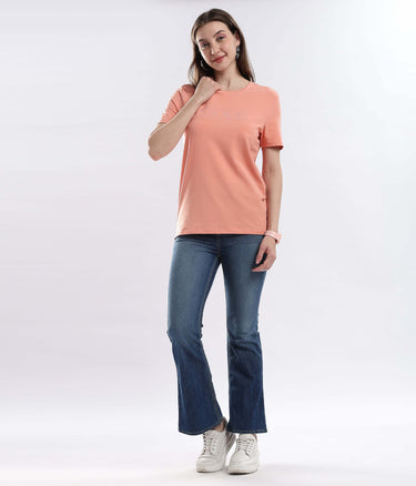 Model wearing Womens casual t-shirt Ember Orange cotton tshirt, showcasing its stretchable, waterproof, and anti-odour features.