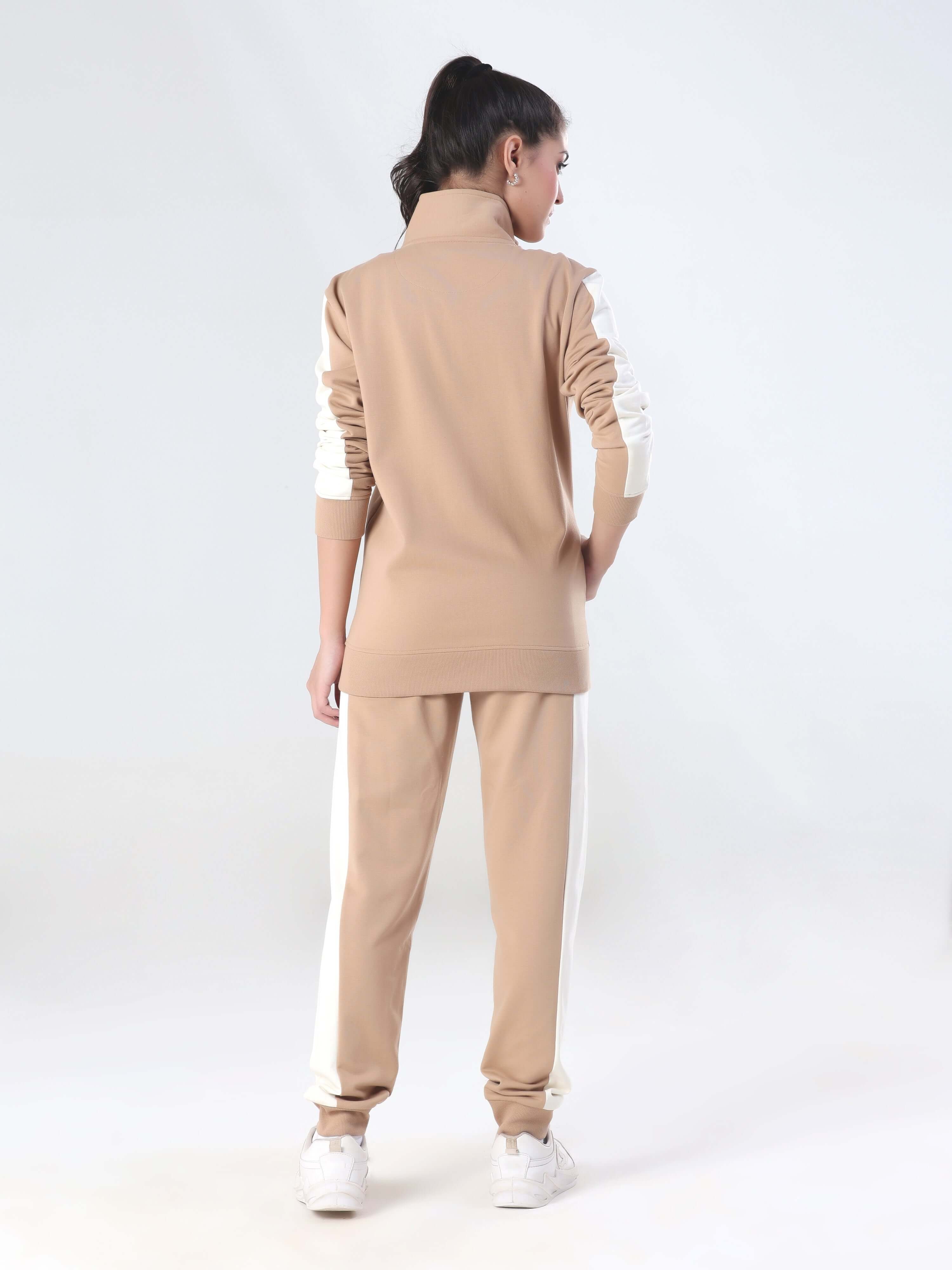 Back view of a woman wearing the Turms Intelligent coord set in beige, featuring joggers and a stylish jacket.