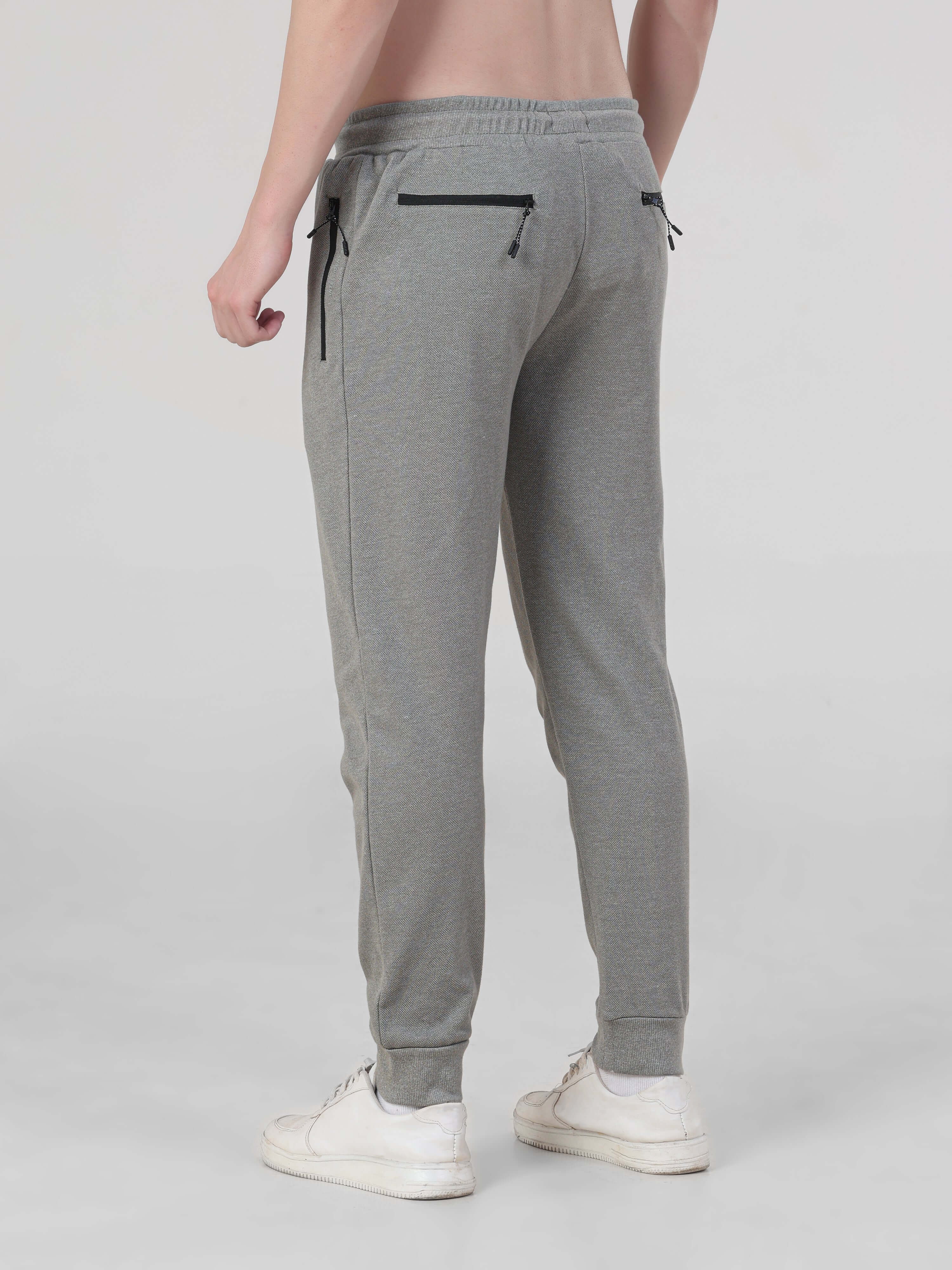 Men's grey jogger pants from Turms, featuring waterproof, anti-stain, anti-odour fabric for travelers, combining style and functionality.