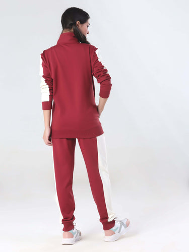 Back view of a woman in a ruby red Turms Intelligent coord set, featuring joggers and a stylish jacket, perfect for everyday wear.