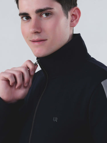 Model wearing a stylish black zip-up jacket, promoting Turms Intelligent Cord Set for men and women.