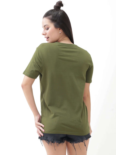 Woman wearing green round-neck T-shirt from the back, paired with black frayed denim shorts.