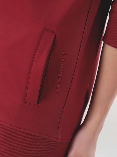Close-up of a women's red jogger set pocket, showcasing Turms Intelligent Cord Set's style and quality.