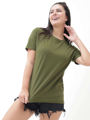 Woman wearing a round-neck, olive green Turms T-shirt with black denim shorts, showcasing stylish and stain-proof apparel for everyday use.