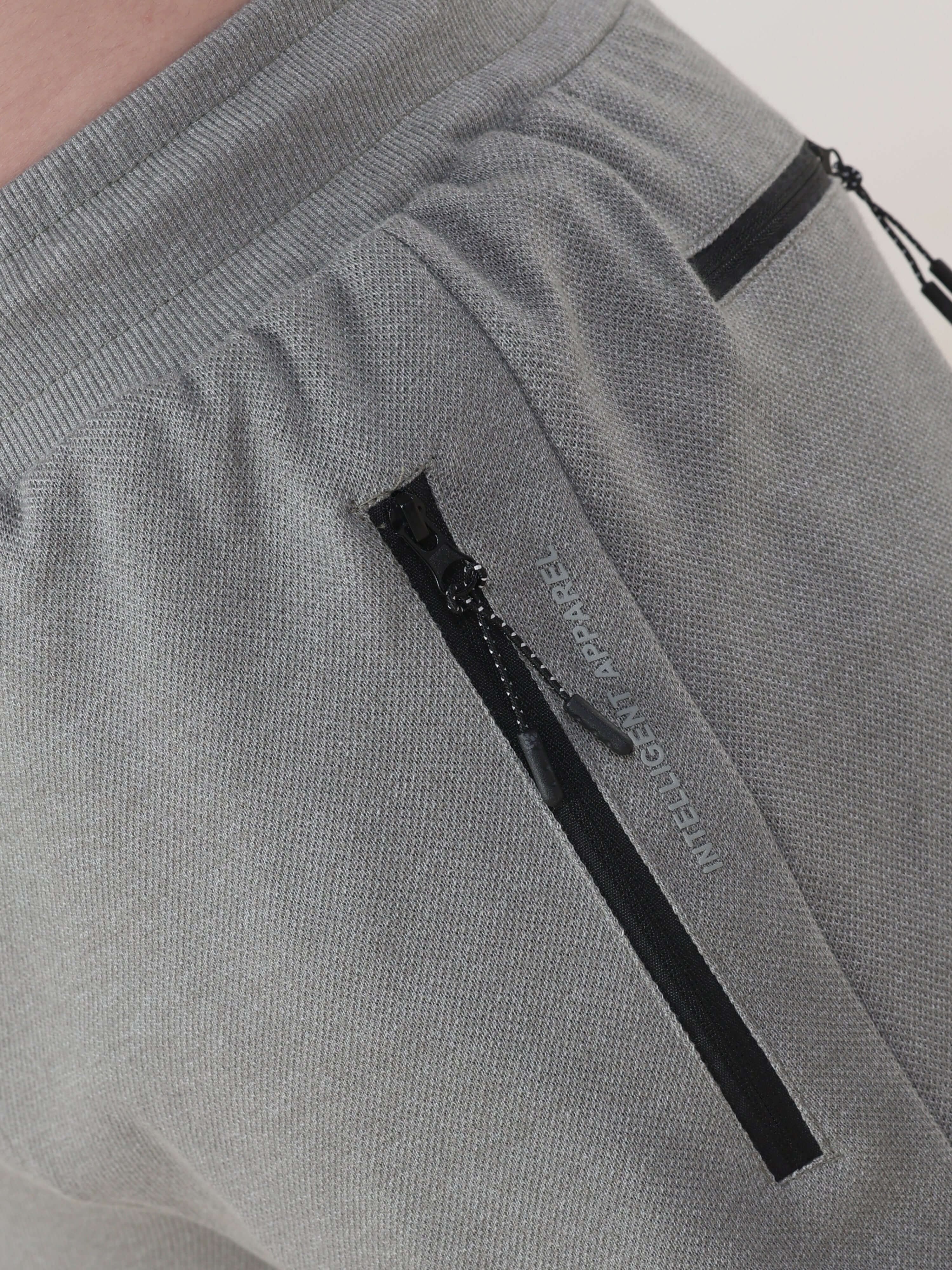 Grey Turms Intelligent Jogger showcasing waterproof, anti-stain features with sleek design and secure zip pockets.