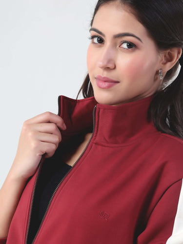 Close-up of woman wearing red Turms jacket from the Intelligent Cord Set, showcasing stylish, sporty design.
