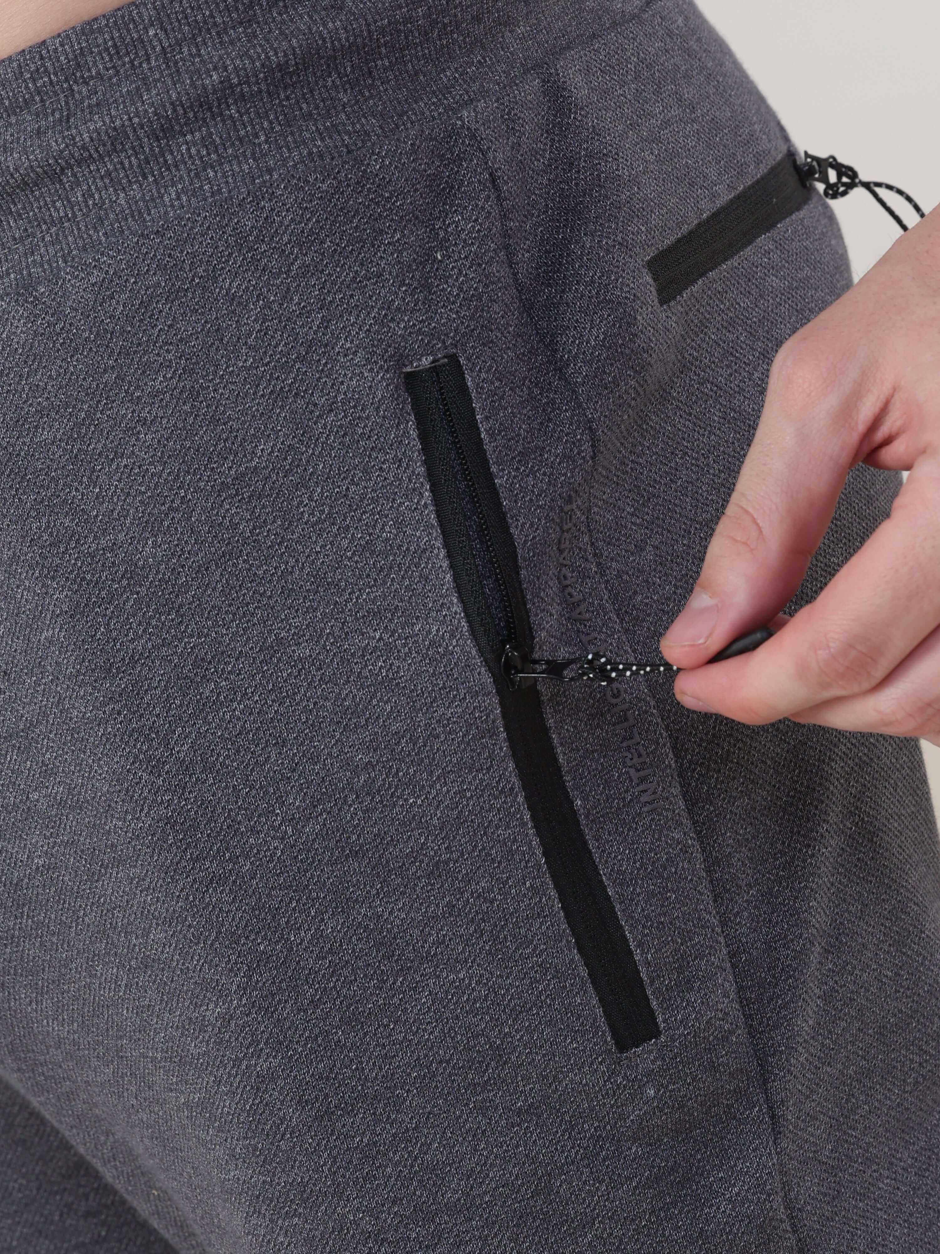 Close-up of Turms charcoal men's jogger with waterproof zippers, highlighting stretchable and anti-odour features.