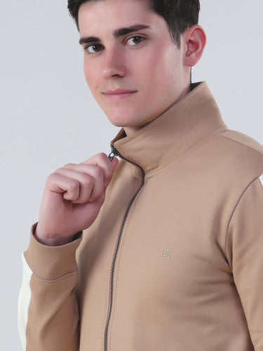 Young man wearing a stylish brown zip-up jacket from the Turms Intelligent Cord Set, showcasing modern design.