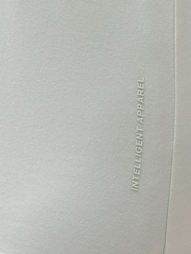 Close-up of Turms intelligent apparel showcasing the anti-stain, anti-odour, and stretchable fabric in light grey color