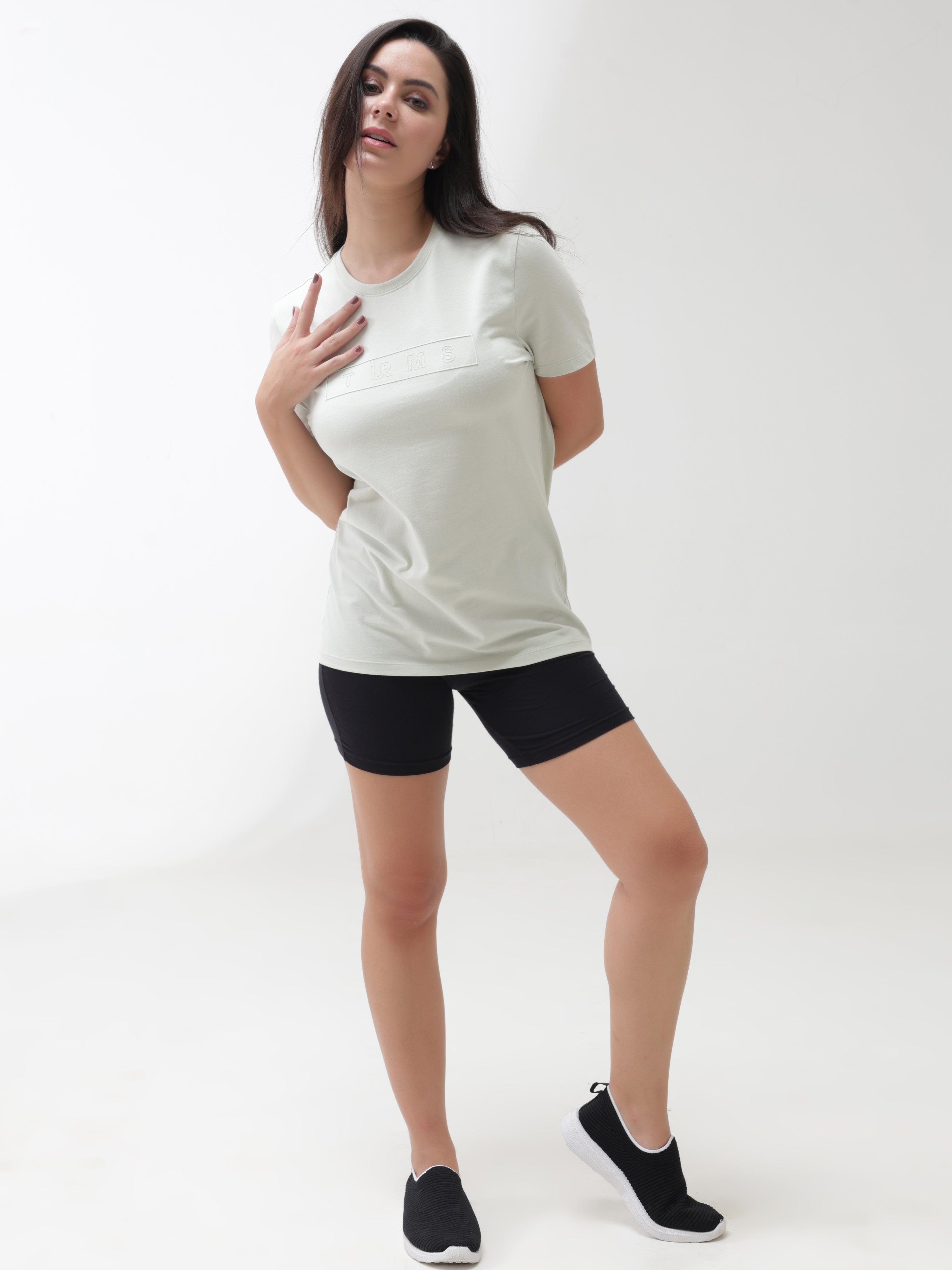 Woman wearing Lime Enigma anti-stain, anti-odor, stretchable Turms T-shirt with tailored fit and round neck, ideal for trending intelligent apparel.