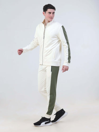 Man in Desert Snow co-ord set, featuring a cream jacket and olive joggers, stylish and water-resistant, from Turms Intelligent Apparel.