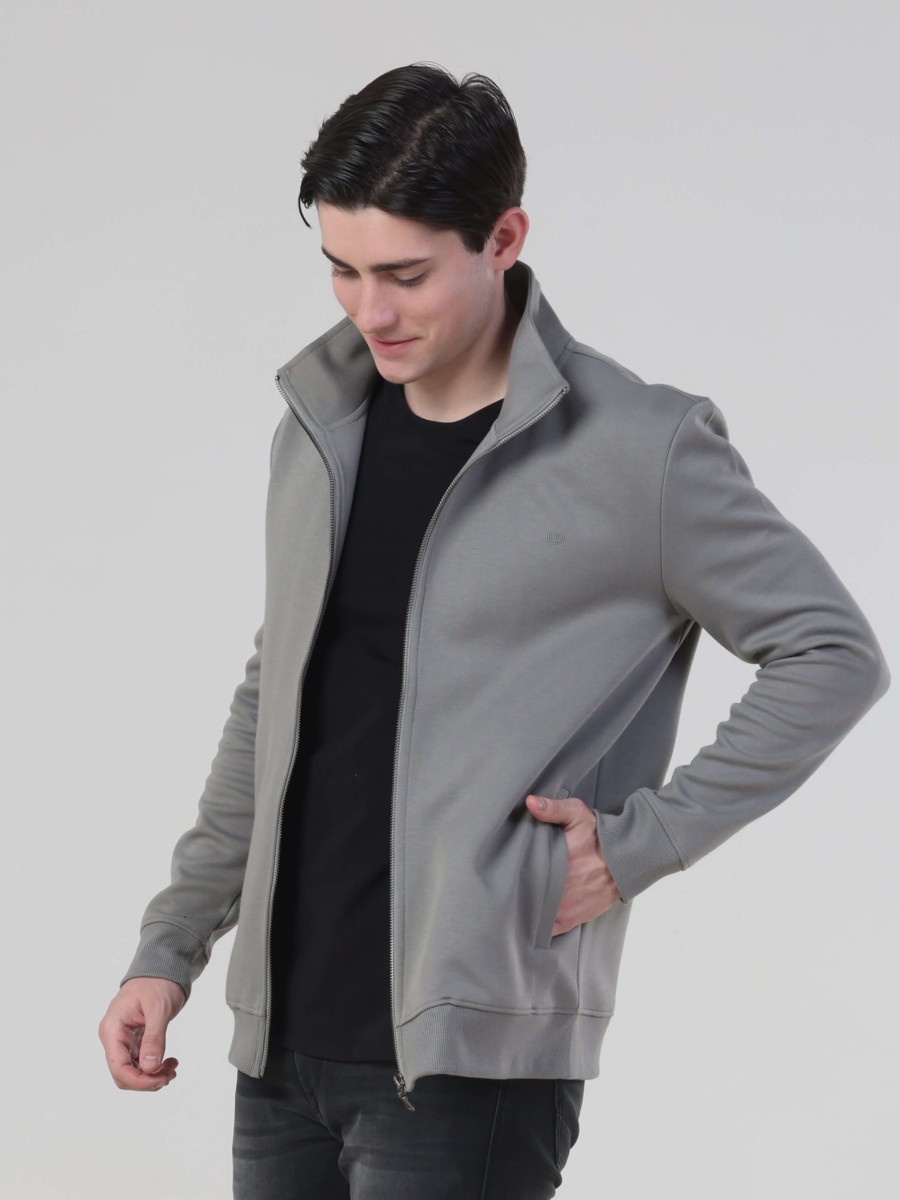 Man in gray Spacemarine Traveller jacket, showcasing its stylish, comfortable design and durable features.