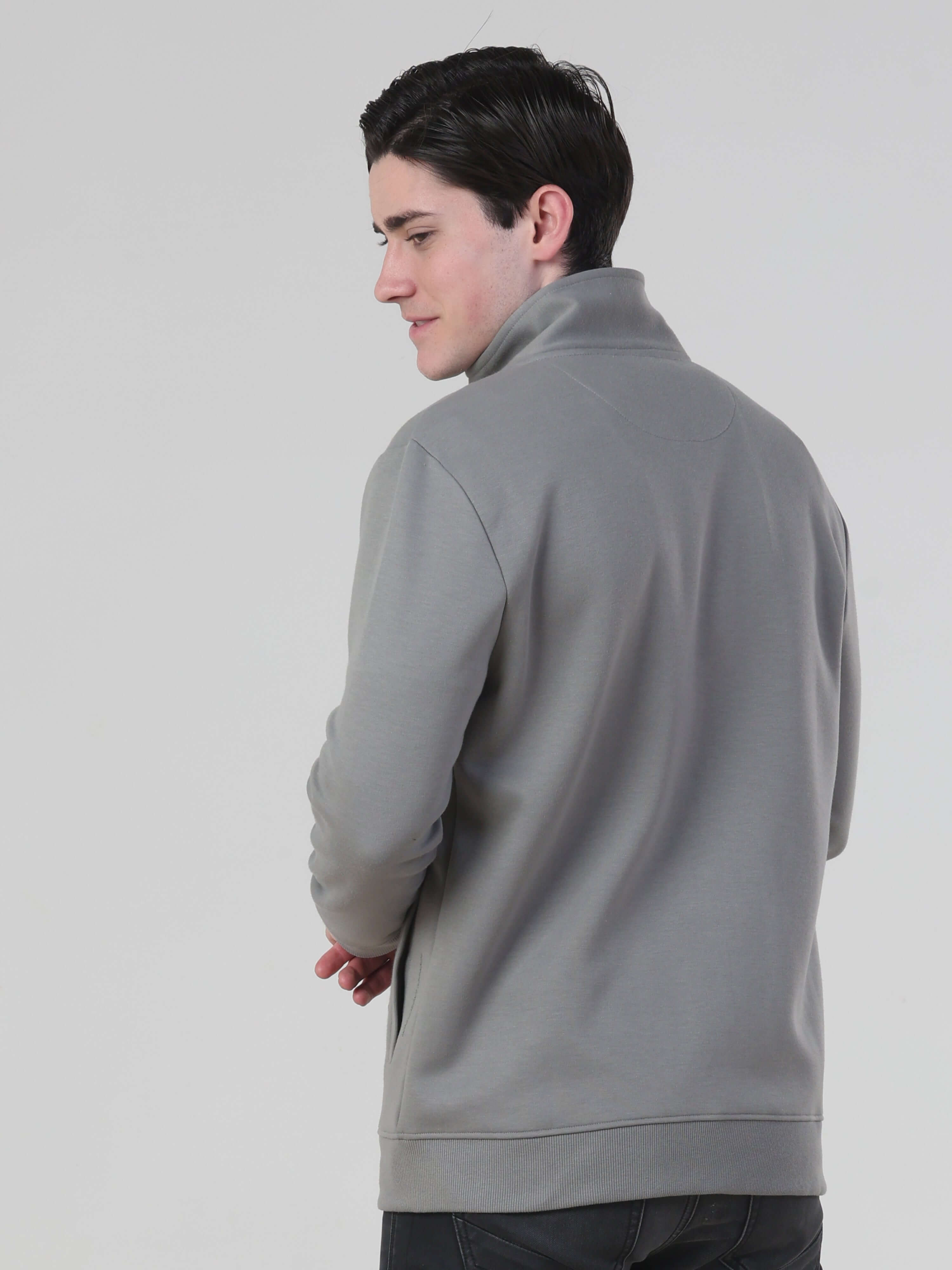 Back view of a man wearing a grey Turms Intelligent Traveller Jacket, showcasing its stylish and functional design.