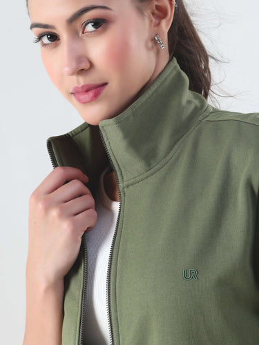 Close-up of woman wearing olive green jacket, showcasing stylish design and elegant beauty, representing winter fashion.
