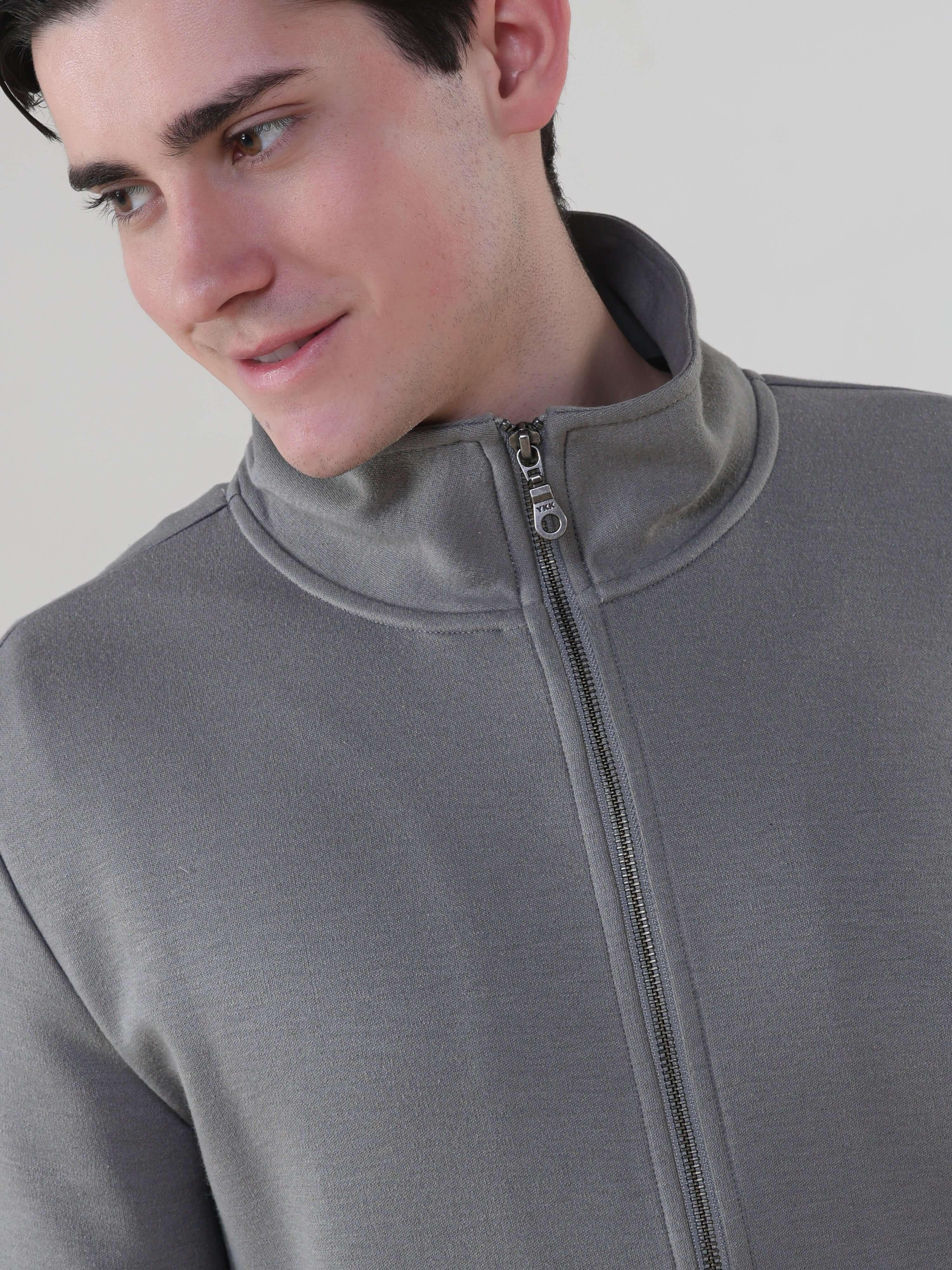 Model wearing a grey Turms Intelligent Traveller Jacket, showcasing style and functionality in anti-stain, waterproof fabric.