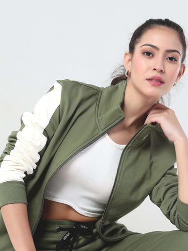 Woman in stylish olive green Turms coord set featuring a jacket and joggers, perfect for comfortable travel wear.